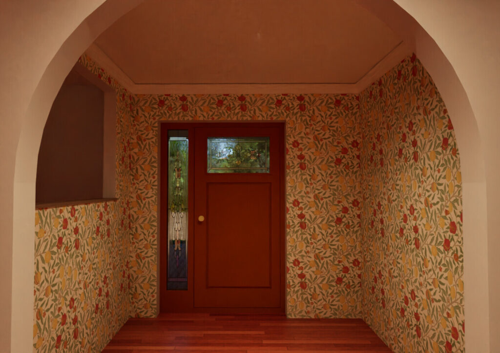 Fort Collins Remodel showing an arched entryway with wooden door, opening up the space and creating an inviting entryway.